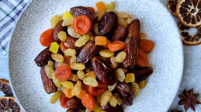Dried apricots, raisins, and candied fruits as ingredients for baked goods and sweets. Dried fruits as a food background for your design
