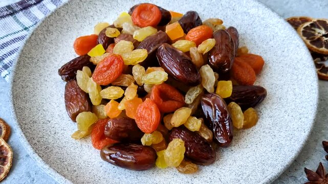Dried apricots, raisins, and candied fruits as ingredients for baked goods and sweets. Dried fruits as a food background for your design