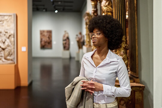 female African American looking at exhibition