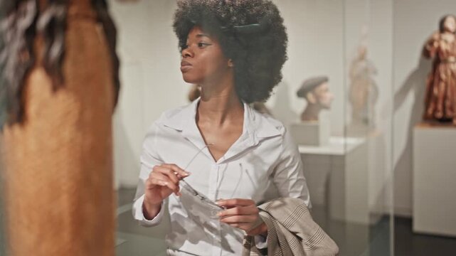female African American looking at exhibition