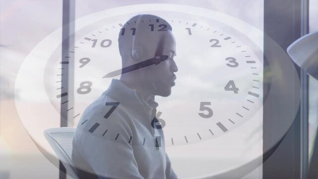 Speaking headset-clad man in light shirt answering call at office, clock overlay tracking time