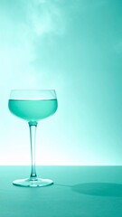 Obraz premium Clear Liquid In A Tall Stem Glass On A Flat Surface With Soft Lighting