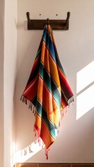 Obraz premium Vibrant Woven Blanket with Geometric Pattern Hanging on Wall