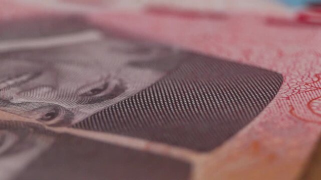 A detailed macro pan across Indonesian Rupiah banknotes (2022 series), highlighting national heroes, intricate printing, and vibrant colors of various denominations from 1,000 to 100,000 Rupiah.