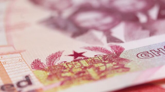 Macro view of the 200 Ghana Cedi note. Features include the Big Six, Independence Arch, and the Ghanaian Coat of Arms. Highlights security threads and the "Gye Nyame" Adinkra symbol.