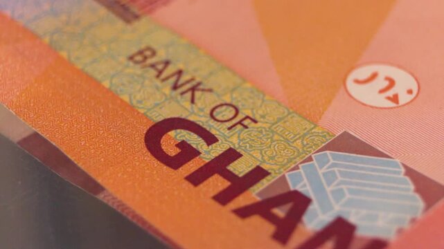 A macro close-up of the 200 Ghana Cedi note. The video highlights the purple-hued design, the color-shifting "Gye Nyame" security symbol, and the bold Bank of Ghana typography on the high-value bill.