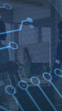 Vertical video: Woman gesturing causing circuit overlay across office screens while peer listening