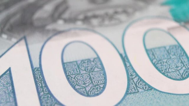 A macro exploration of a 100 Ghana Cedi banknote, showcasing intricate security patterns and vibrant teal ink. The footage highlights the detail and craftsmanship of Ghana's high-denomination currency