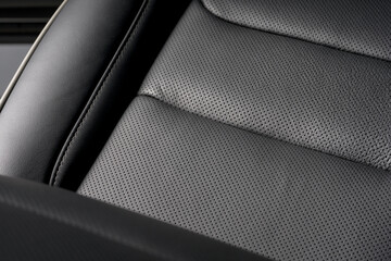 Closeup shot of the black seat surface for driver inside a car © Jesus