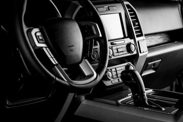 Obraz premium Car interior dashboard with modern details, multimedia screen system, gear lever and luxury concept - black and white