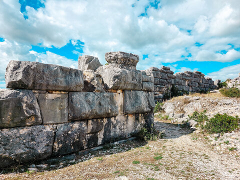 Close-up of massive megalithic stone wall in ancient Illyrian city of Daorson, Bosnia and Herzegovina. Detailed texture of historic ruins, archaeological background and ancient construction.