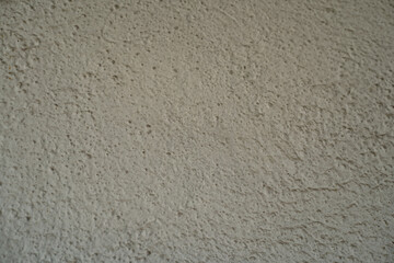 Fototapeta premium Plaster wall texture with subtle rough pattern, natural cement surface background, minimal abstract backdrop, clean stone or concrete detail