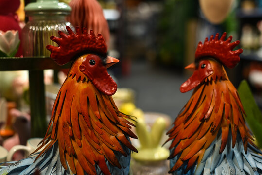 Easter holiday. Colorful metal roosters at a decor store.