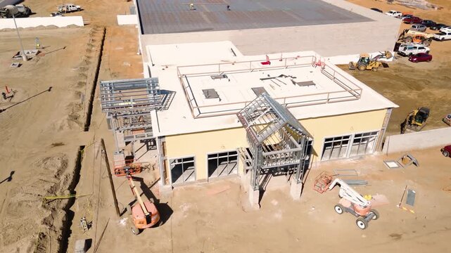 Aerial View of Automotive Dealership Construction Site with Steel Structure and Metal Roof