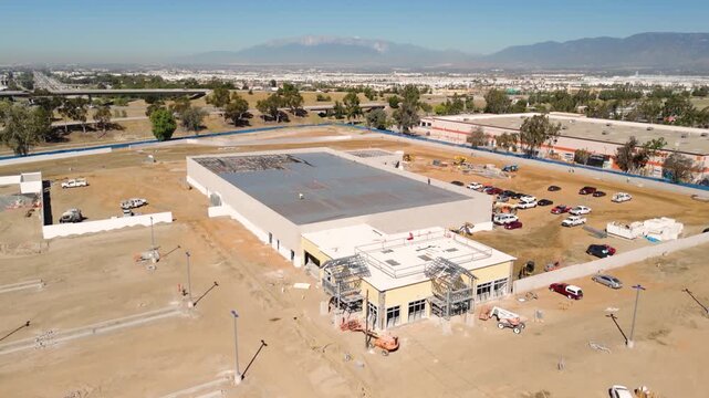Aerial View of Automotive Dealership Construction Site with Steel Structure and Metal Roof