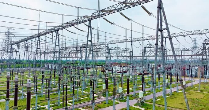 Electrical substation with high-voltage transformers and power transmission lines for industrial energy supply and utility infrastructure.