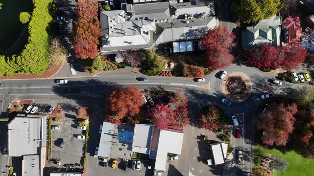 Stirling, South Australia: 4K aerial drone footage featuring leafy roundabouts, autumn-coloured trees, roundabout, streets, shops, houses, rural traffic, vehicles and scenic Adelaide Hills landscape