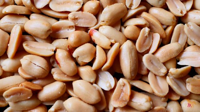 Detailed rotating view of salted peanuts, highlighting natural ingredient and snack appeal, suitable for marketing, menu visuals and culinary projects