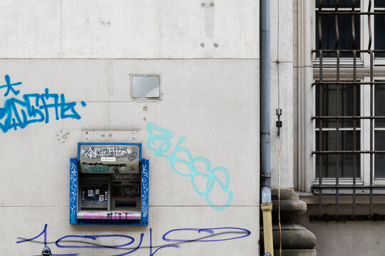 ATM covered in graffiti on urban wall, Krak&oacute;w Poland street scene