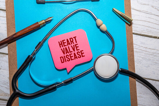 a photo of hand holding miniature heart with 3 wooden blocks.