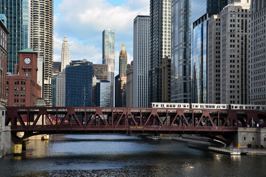 A train crosses the Chicago River with the skyline in the background in downtown Chicago.