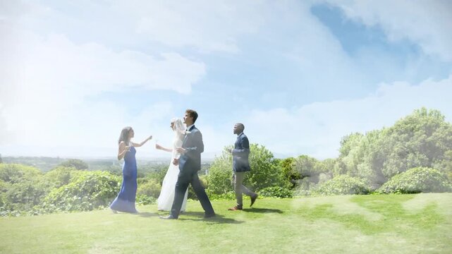 Wedding party walking across grassy lawn, camera tightening, revealing veil lifting while toasting