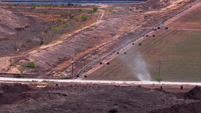 Dust Devil Spinning Down Unpaved Rural Road. Aerial Tracking Shot.