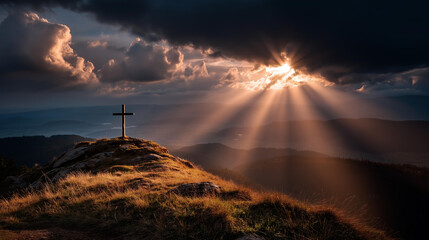 Close up of morning sunlight breaking through scattered clouds above a hilltop cross the light rays forming dramatic crepuscular beams radiating from behind the cross creating