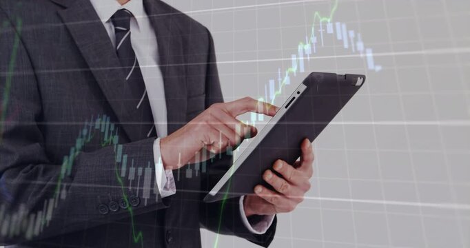 Man tapping tablet before grid, initiating candlesticks overlaying torso and analyzing markets
