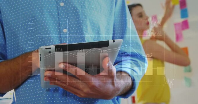 Vertical video: Woman tapping tablet and animating charts while peer placing stickies for business