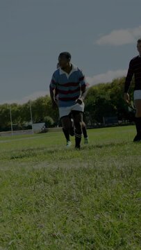 Vertical video: Man in striped rugby breaking after contest to gain ground, bars covering chasers