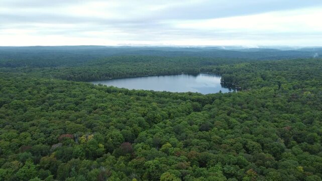Aerial over expansive wilderness of crown land in the Tory Hill area of Highlands East, Ontario, Canada. Flying north from Buckskin Lake towards Monrock Lake on an overcast summer afternoon.