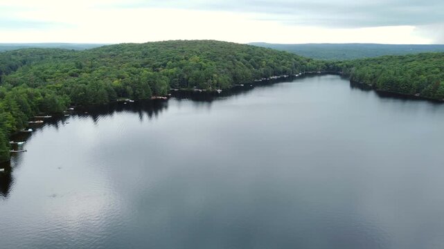 Flying over Buckskin Lake on an overcast, late summer afternoon. Aerial above the expansive wilderness of crown land located in the Tory Hill area of Highlands East, in southern Ontario, Canada.