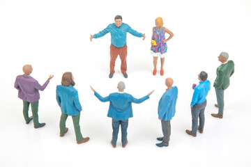 Naklejka premium Group of miniature people interacting in a circle during a discussion at a casual gathering in a bright setting