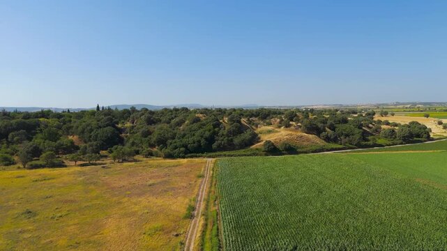 Tevfikiye, Turkey. The ancient city of Troy archaeological site and ruins surrounded by agricultural fields on a sunny summer day in Canakkale Province. Aerial view