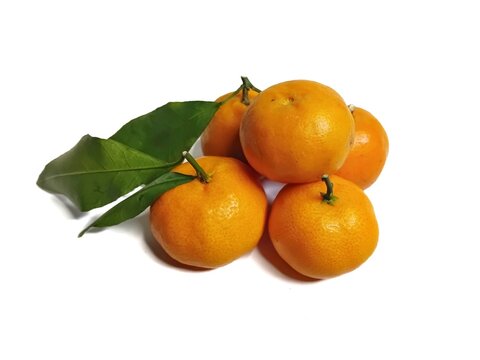 Fresh mandarin oranges with green leaves isolated on a white background. Sweet citrus fruits rich in vitamin C.