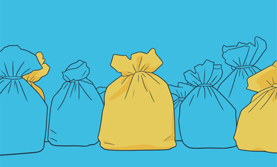 Different colored garbage bags are lined up against a blue background during a recycling event at a community center