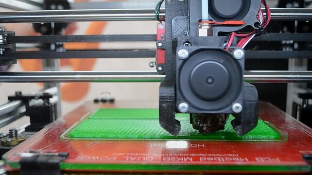 3D printer. 3D printer printing object close-up. 3D printer printing model green color. Working 3D printer. Concept printing technology. New modern additive progressive technology. FDM technologies