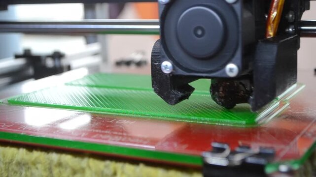 3D printer. 3D printer printing object close-up. 3D printer printing model green color. Working 3D printer. Concept printing technology. New modern additive progressive technology. FDM technologies