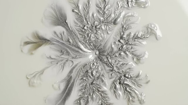 Silver Liquid Blooms Unfold Slowly Across Glossy Surface