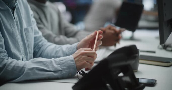 Close Up Hands Junior Stock Broker, as Presenting First Trading Results to Senior Mentor. Man Twirls Pencil in Hands, Shows to Experienced Mentor Growth Indicators, Reporting First Successful Trades.