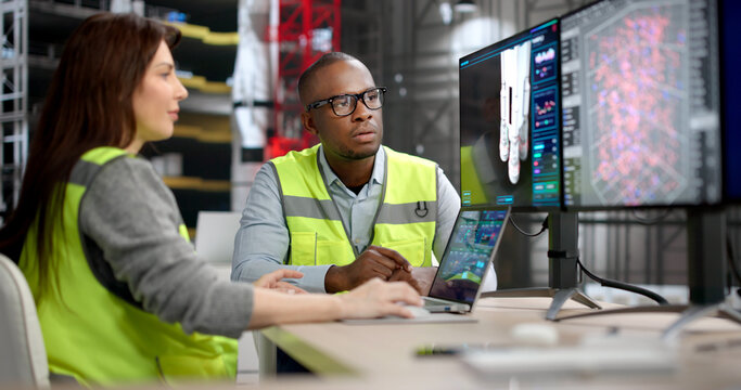 Two Engineers, A Man And Woman, Discuss Rocket Engine Designs