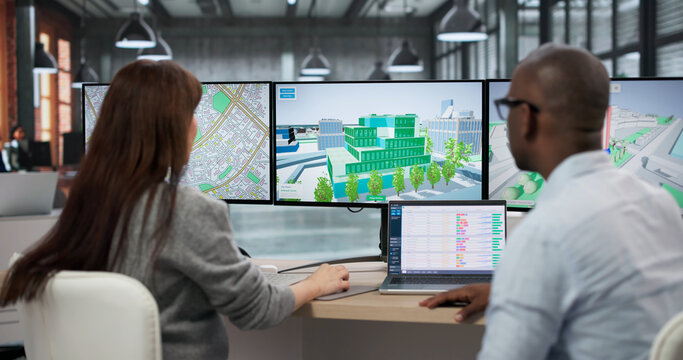 Young Man And Woman Use Computers Designing BIM 3D Models