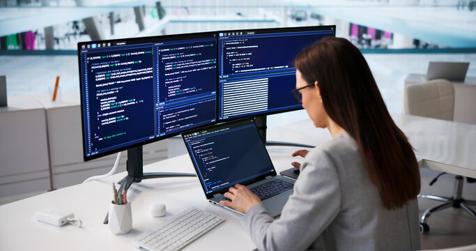 Woman Software Developer Writing Code On Laptop