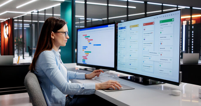 Project Manager Analyzes Comprehensive Multi-Screen Schedule With Focus