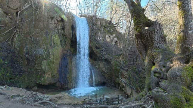 Side View of Forest Waterfall with Tree and Sunlight. Ozren Mountain, Sokobanja region (Ripaljka). Balkans, Serbia.