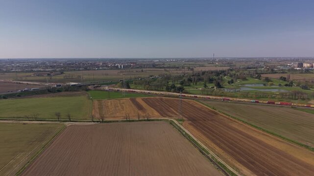 Expansive Farmland Panorama: A sprawling aerial perspective of agricultural lands unfolds under a vast, cloudless sky, showcasing the natural beauty of cultivated fields.