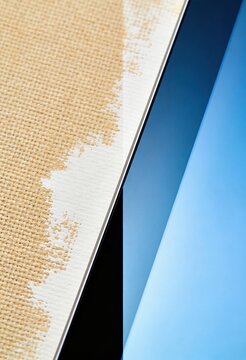 Close up of linen canvas meeting digital tablet screen in a split composition representing the evolution of art from traditional analog media to modern digital tools