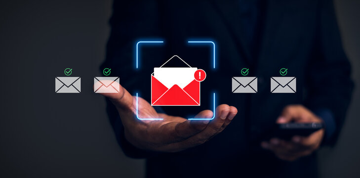 Hand holding smartphone with glowing email security interface showing phishing alert warning, spam filtering and safe messages, digital cybersecurity concept with verification icons, neon UI overlay