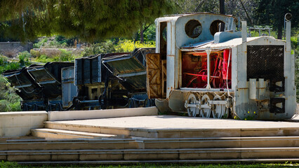 Vintage industrial mining train locomotive on display in rural landscape © Alexandros